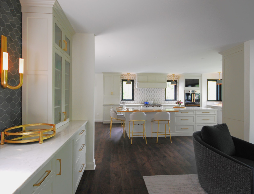 Example of a large transitional l-shaped dark wood floor and brown floor open concept kitchen design in Philadelphia with an undermount sink, shaker cabinets, beige cabinets, quartzite countertops, beige backsplash, porcelain backsplash, paneled appliances, an island and beige countertops