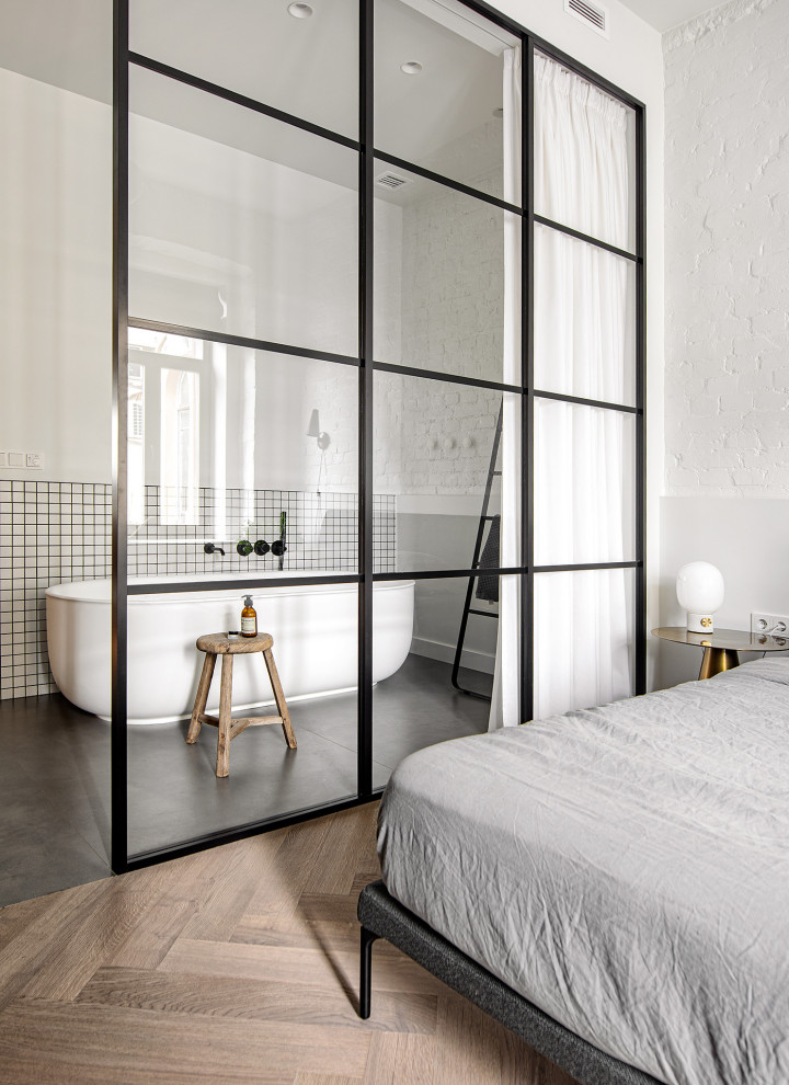 This is an example of a small contemporary bathroom in Moscow with a freestanding tub, white tile, white walls, mosaic tile, grey floor and brick walls.