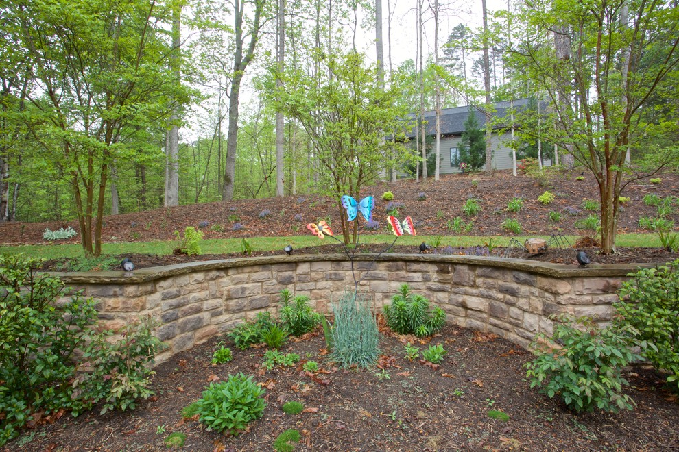 This is an example of a mid-sized transitional side yard retaining wall landscape.