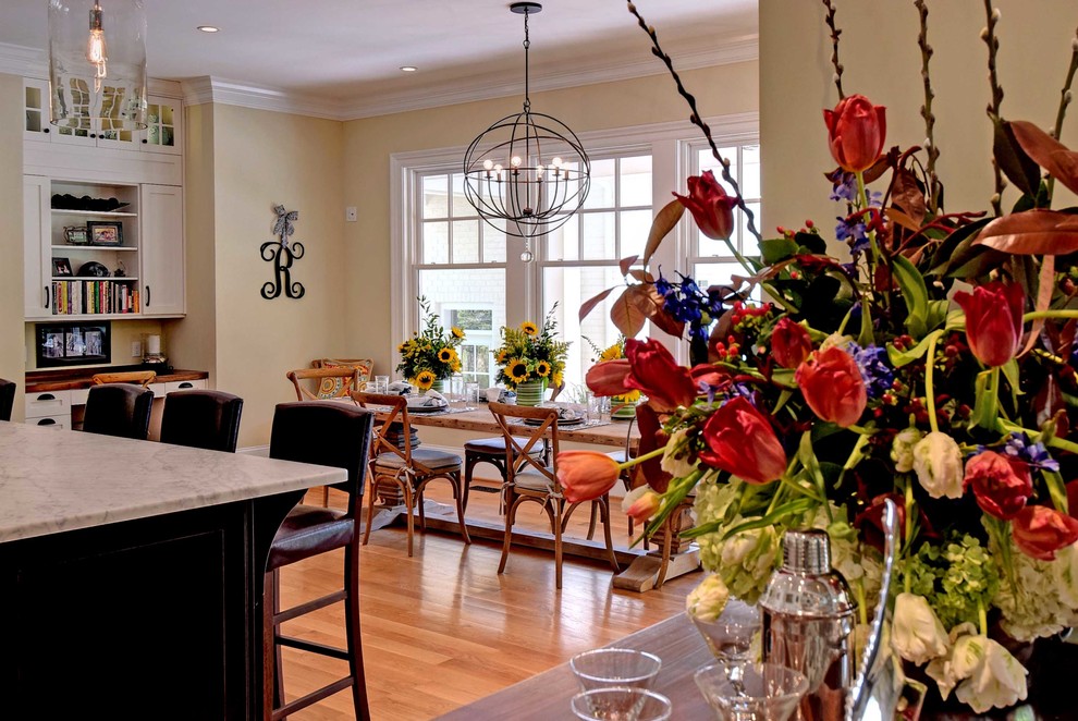 Eat-in kitchen - transitional medium tone wood floor eat-in kitchen idea with an undermount sink, shaker cabinets, white cabinets, marble countertops, gray backsplash, subway tile backsplash, stainless steel appliances and an island