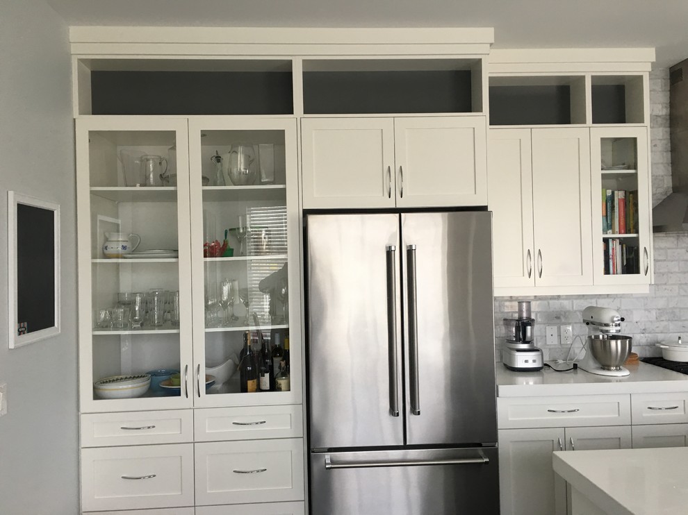 Example of a transitional kitchen design in Calgary