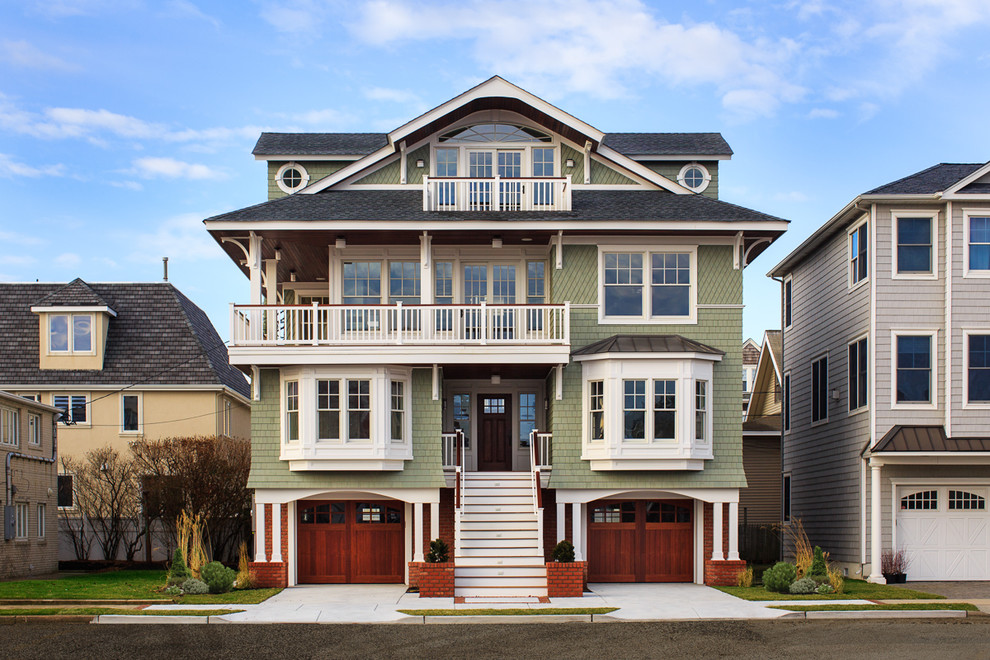 This is an example of a large beach style three-storey green exterior in Philadelphia with wood siding.