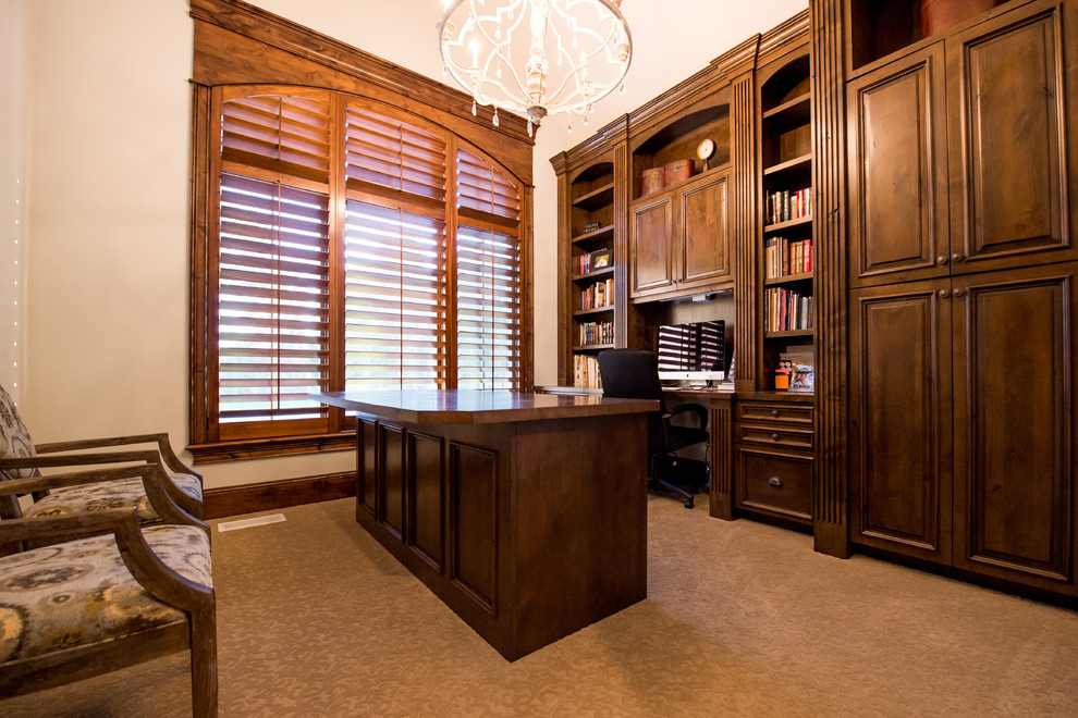 Large traditional study room in Other with beige walls, carpet, no fireplace, a freestanding desk and brown floor.