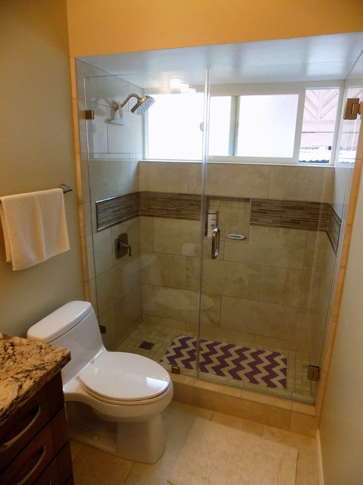 Photo of a transitional master bathroom in San Diego with flat-panel cabinets, medium wood cabinets, an alcove shower, a one-piece toilet, beige tile, porcelain tile, beige walls, porcelain floors, an undermount sink and engineered quartz benchtops.