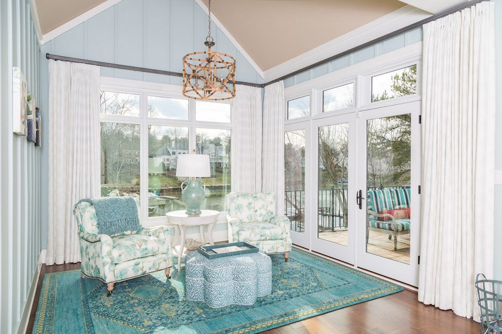 This is an example of a small contemporary sunroom in Charlotte with medium hardwood floors, no fireplace, a standard ceiling and brown floor.
