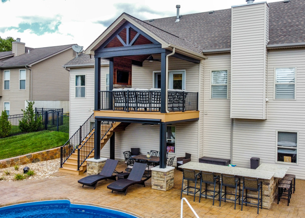 Photo of a medium sized back first floor metal railing terrace in St Louis with a fireplace and a roof extension.