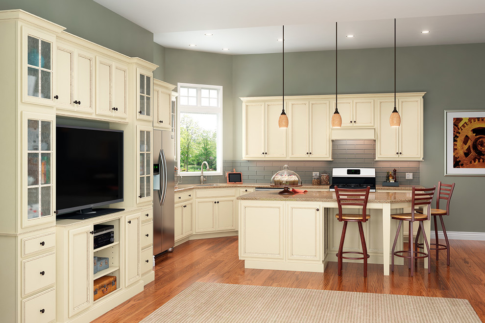 Inspiration for a mid-sized transitional l-shaped medium tone wood floor kitchen remodel in DC Metro with an undermount sink, recessed-panel cabinets, yellow cabinets, quartz countertops, glass tile backsplash, stainless steel appliances and an island