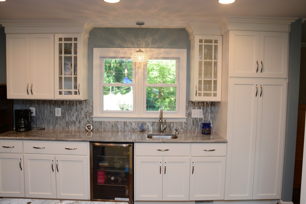Design ideas for a large traditional l-shaped separate kitchen in Baltimore with an undermount sink, recessed-panel cabinets, white cabinets, granite benchtops, blue splashback, stainless steel appliances, dark hardwood floors, with island, brown floor and blue benchtop.