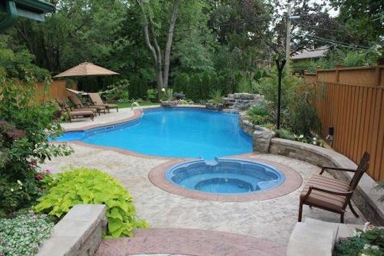 Pool - large backyard custom-shaped pool idea