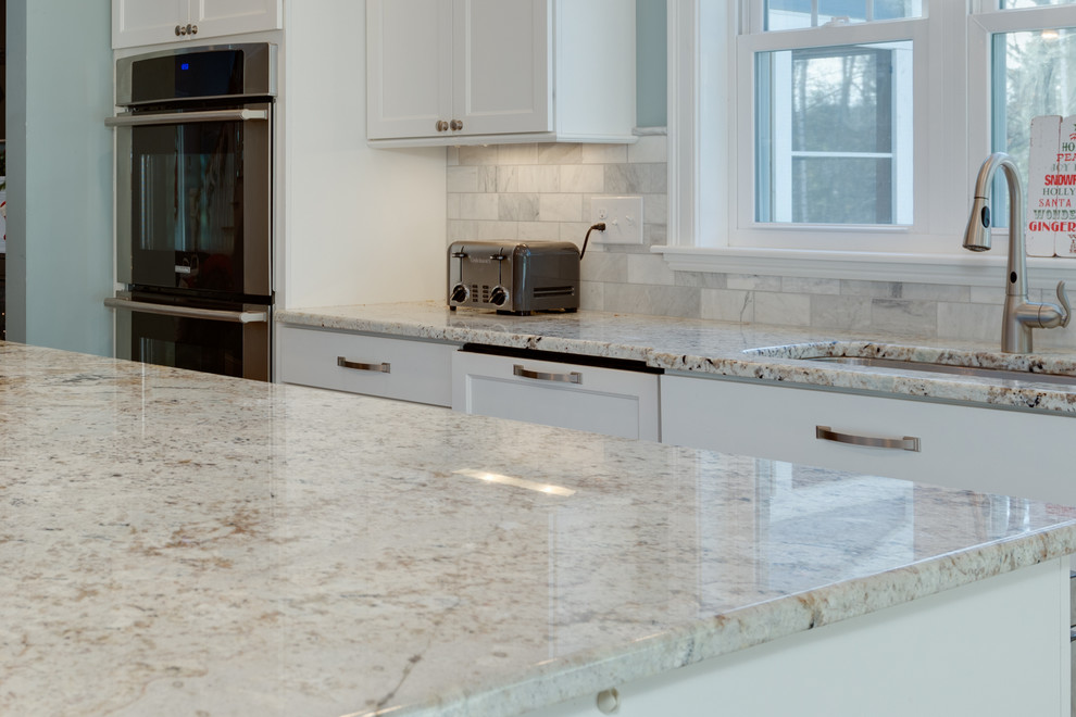 Inspiration for a large transitional u-shaped open plan kitchen in Boston with an undermount sink, shaker cabinets, white cabinets, granite benchtops, stainless steel appliances, medium hardwood floors and with island.