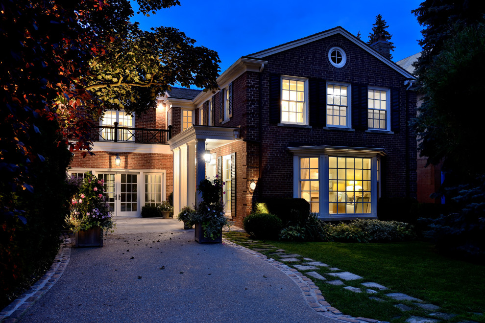 Mittelgroßes, Zweistöckiges Klassisches Einfamilienhaus mit Backsteinfassade, roter Fassadenfarbe, Satteldach, Schindeldach und braunem Dach in Toronto