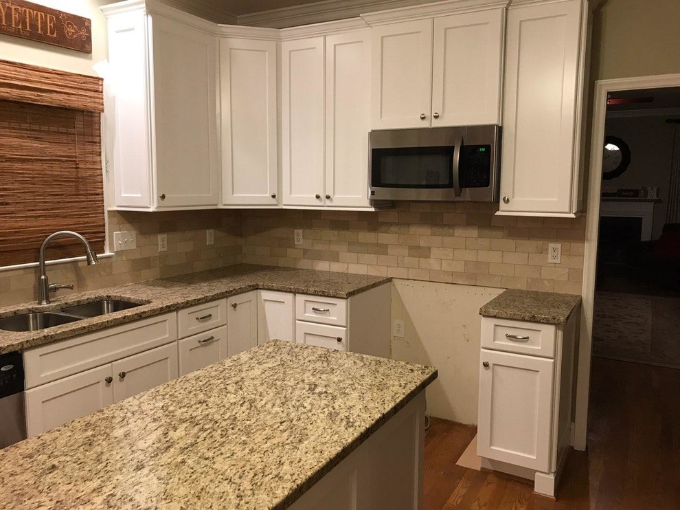 Mid-sized contemporary l-shaped kitchen pantry in Raleigh with an undermount sink, shaker cabinets, white cabinets, granite benchtops, beige splashback, porcelain splashback, stainless steel appliances, medium hardwood floors, with island and brown floor.