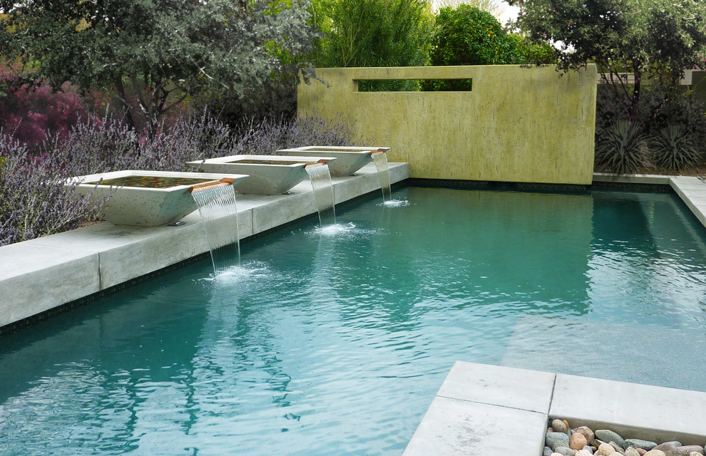 Design ideas for a contemporary l-shaped pool in Phoenix with a water feature.