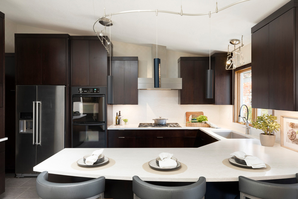 Design ideas for a mid-sized contemporary u-shaped eat-in kitchen in Minneapolis with an undermount sink, flat-panel cabinets, dark wood cabinets, quartz benchtops, grey splashback, black appliances, vinyl floors, a peninsula, grey floor and grey benchtop.