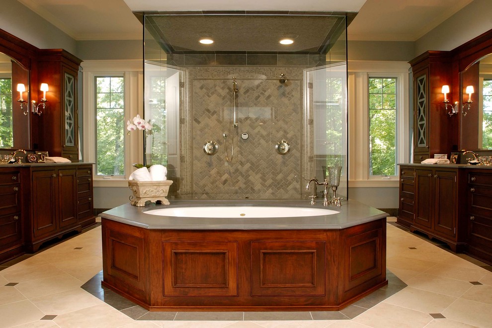 Expansive traditional master bathroom in Chicago with a double shower, recessed-panel cabinets, dark wood cabinets, an undermount tub, beige tile, blue walls, limestone floors, an undermount sink, limestone benchtops, limestone and grey benchtops.