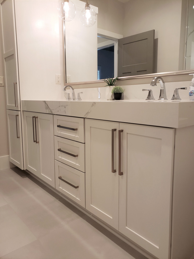 Example of a mid-sized transitional master double-sink doorless shower design with shaker cabinets, white cabinets, an undermount sink, white countertops and a built-in vanity