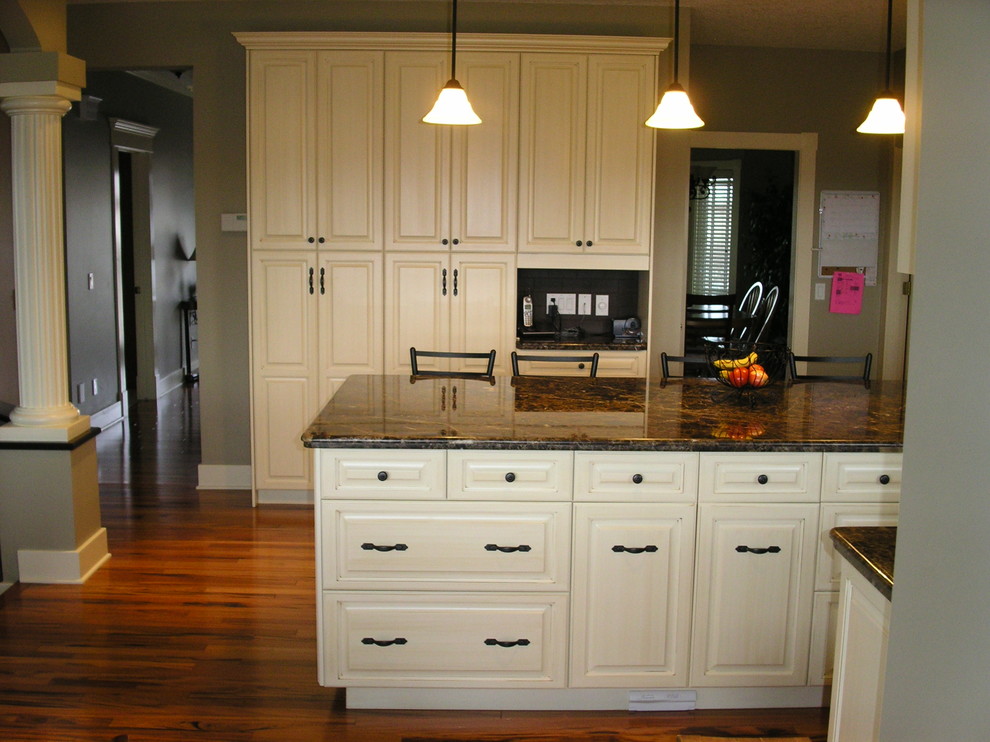 Mountain style kitchen photo in Calgary with raised-panel cabinets and distressed cabinets