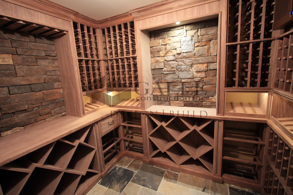 Inspiration for a mid-sized traditional wine cellar in Toronto with slate floors and storage racks.