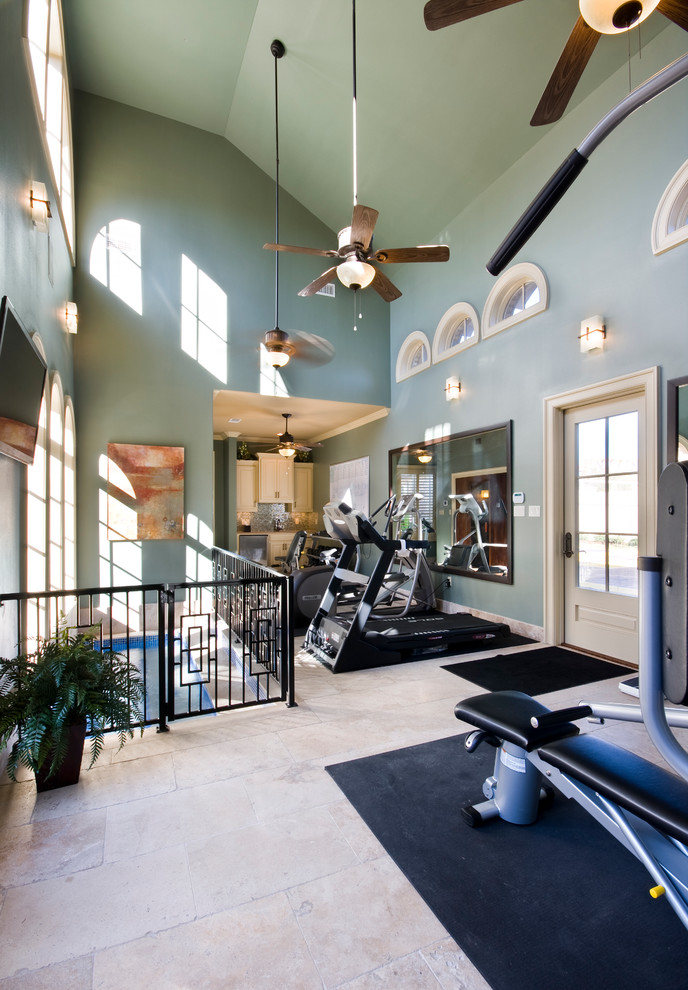 Large traditional multipurpose gym in New Orleans with blue walls and travertine floors.