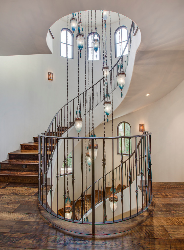 Design ideas for a large mediterranean wood spiral staircase in Los Angeles with wood risers.