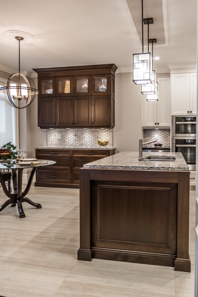 Eat-in kitchen - mid-sized transitional l-shaped ceramic tile eat-in kitchen idea in Toronto with an undermount sink, shaker cabinets, granite countertops, mosaic tile backsplash, stainless steel appliances, an island, gray backsplash and white cabinets