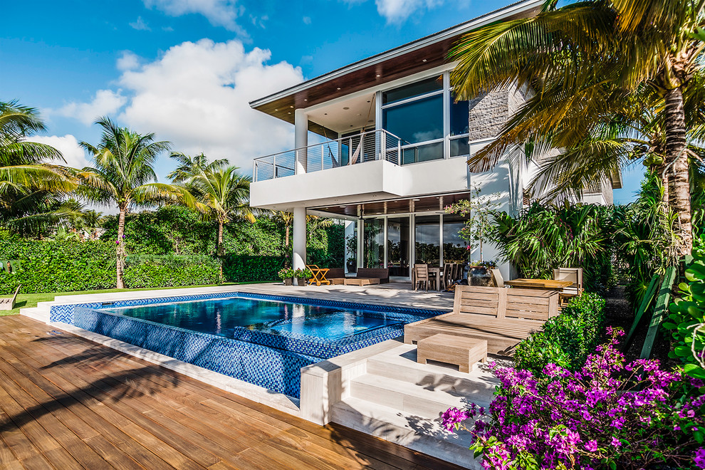This is an example of a mid-sized contemporary backyard rectangular pool in Miami.
