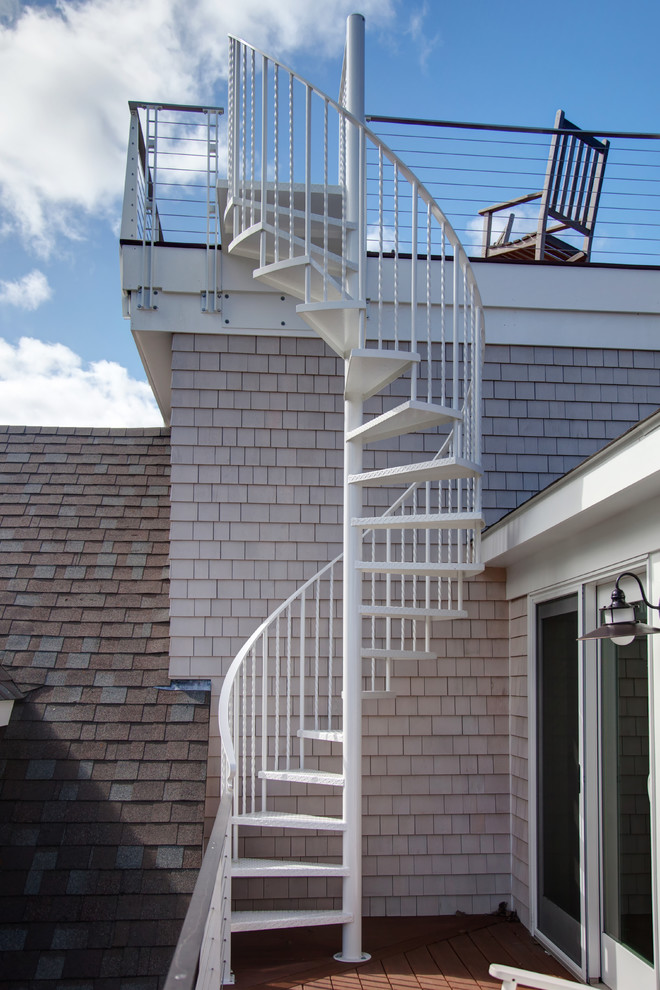 Inspiration for a mid-sized beach style metal spiral staircase in Boston with open risers and metal railing.