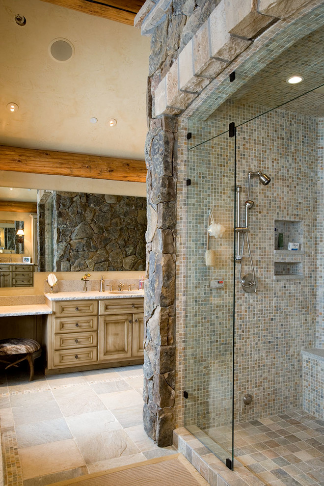 Large country master bathroom in Denver with beaded inset cabinets, beige cabinets, an alcove shower, multi-coloured tile, mosaic tile, travertine floors, an undermount sink and engineered quartz benchtops.