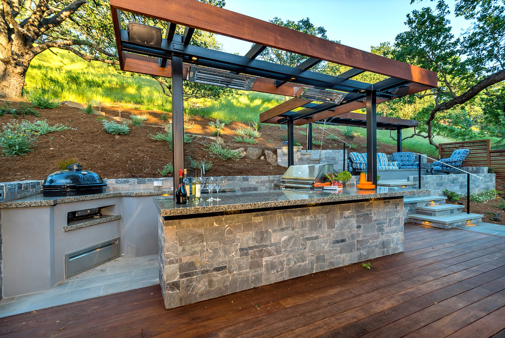 Photo of a large midcentury backyard deck in San Francisco with an outdoor kitchen and a pergola.