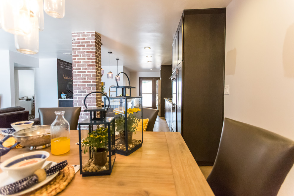 Mid-sized mountain style single-wall concrete floor and gray floor open concept kitchen photo in Phoenix with shaker cabinets, dark wood cabinets, blue backsplash, glass tile backsplash, stainless steel appliances, an island, an undermount sink and quartzite countertops