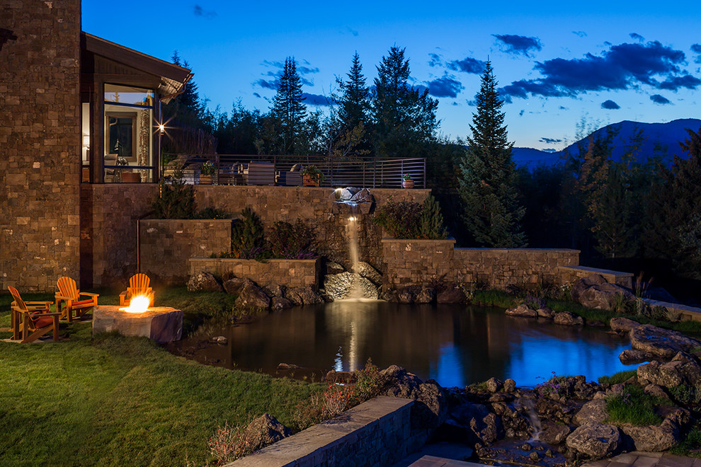 Photo of an expansive country backyard full sun garden in Other with natural stone pavers.