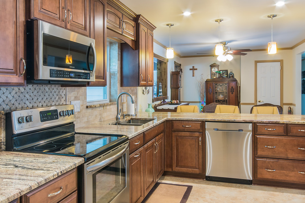 Inspiration for a large galley open concept kitchen remodel with raised-panel cabinets, brown cabinets, granite countertops and a peninsula