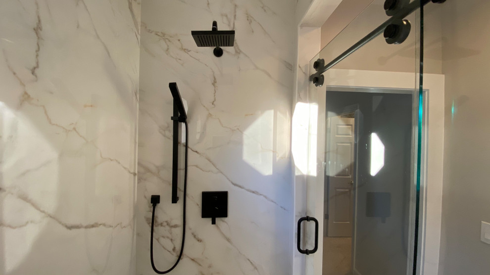 Example of a large master porcelain tile porcelain tile and double-sink bathroom design in Other with flat-panel cabinets, white cabinets, a two-piece toilet, beige walls, an undermount sink, tile countertops and a built-in vanity