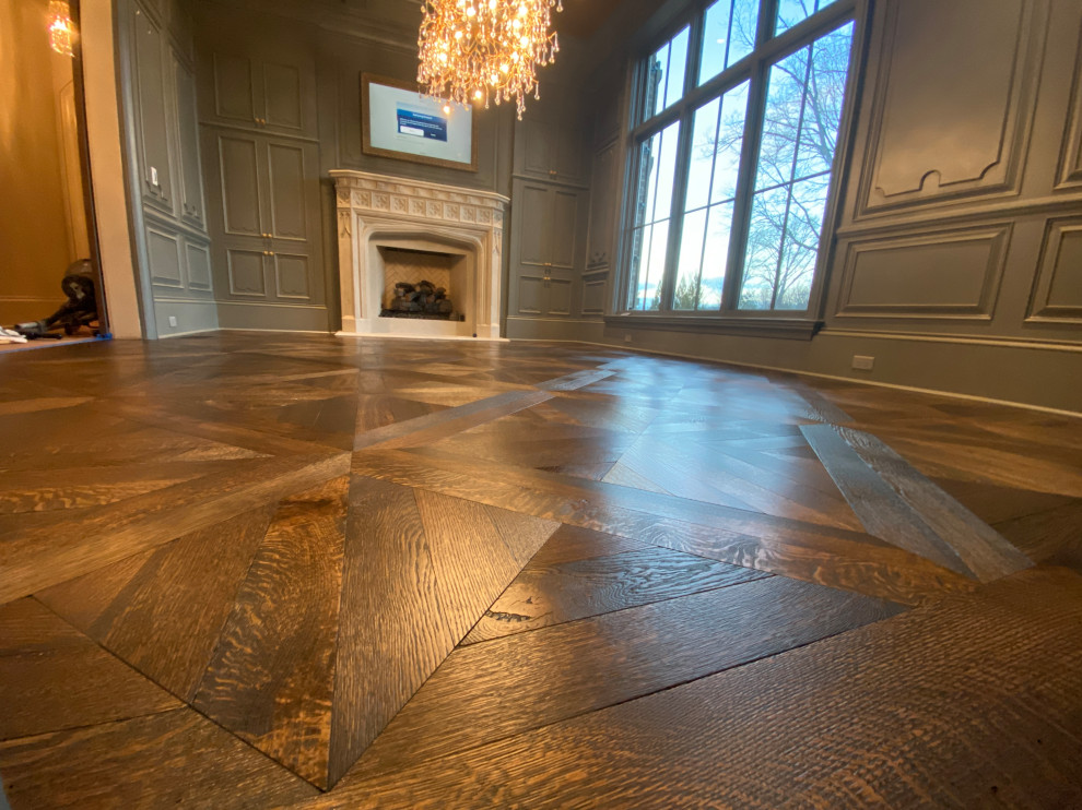 Inspiration for a mid-sized victorian dark wood floor, brown floor, tray ceiling and wall paneling great room remodel in Atlanta with metallic walls, a standard fireplace and a concrete fireplace