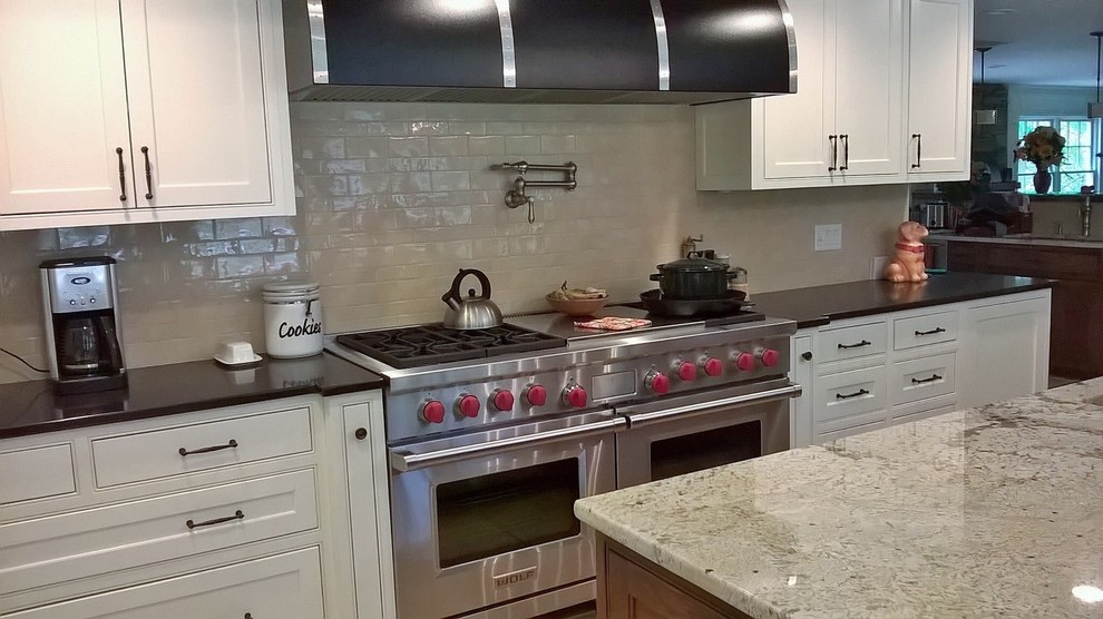 Inspiration for a transitional kitchen remodel in Minneapolis with recessed-panel cabinets, white cabinets, granite countertops and beige backsplash