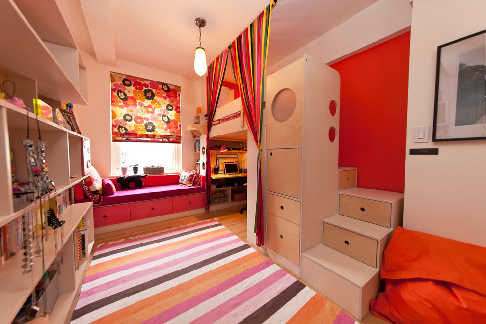 Design ideas for a small contemporary kids' room for girls in New York with multi-coloured walls and light hardwood floors.