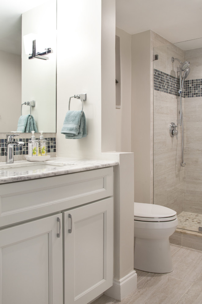 Photo of a small beach style 3/4 bathroom in Miami with recessed-panel cabinets, white cabinets, an alcove shower, gray tile, white walls, marble benchtops and a hinged shower door.