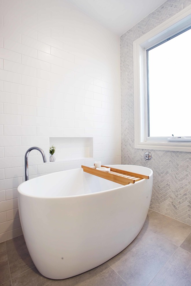 Design ideas for a mid-sized contemporary bathroom in Melbourne with a freestanding tub and subway tile.