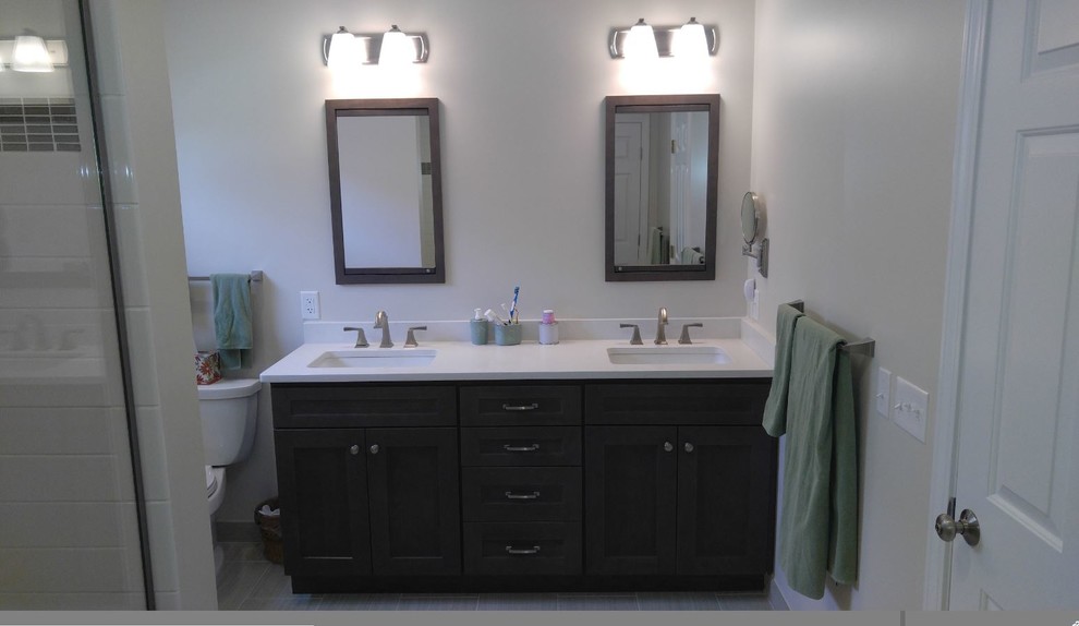 Design ideas for a mid-sized transitional 3/4 bathroom in Boston with recessed-panel cabinets, dark wood cabinets, a two-piece toilet, white tile, subway tile, white walls, an undermount sink, engineered quartz benchtops and white benchtops.