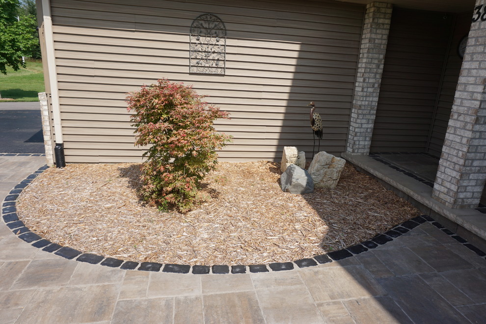 Inspiration for a small traditional front yard patio in Other with concrete pavers and no cover.