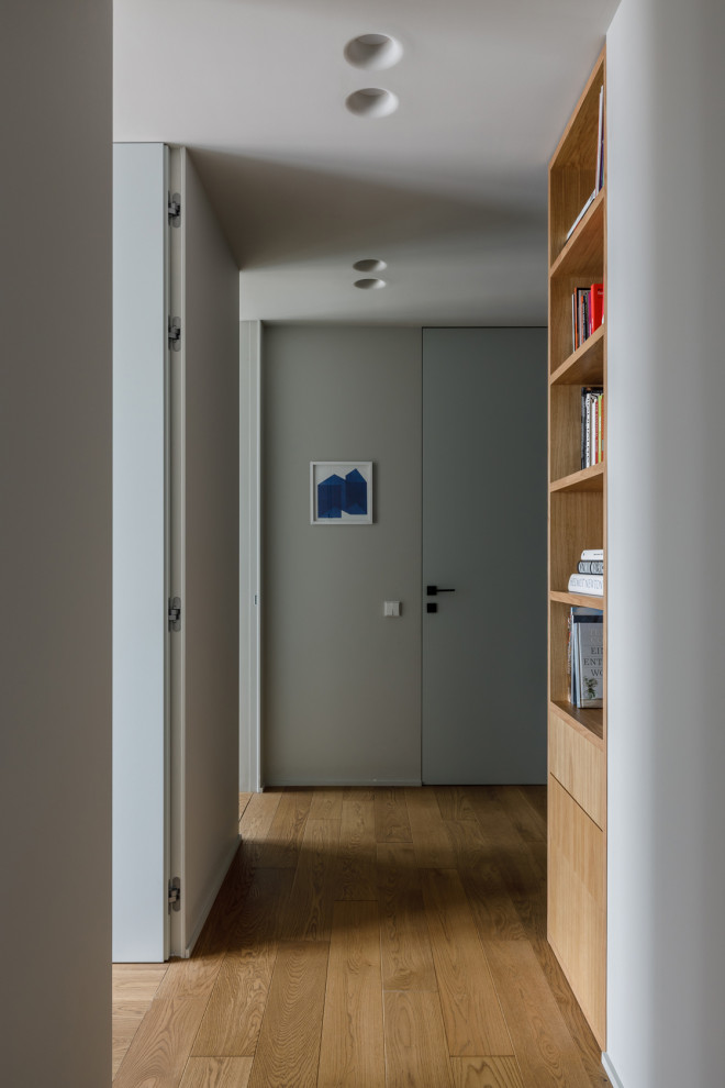 На фото: узкий коридор среднего размера в современном стиле с серыми стенами, паркетным полом среднего тона и коричневым полом