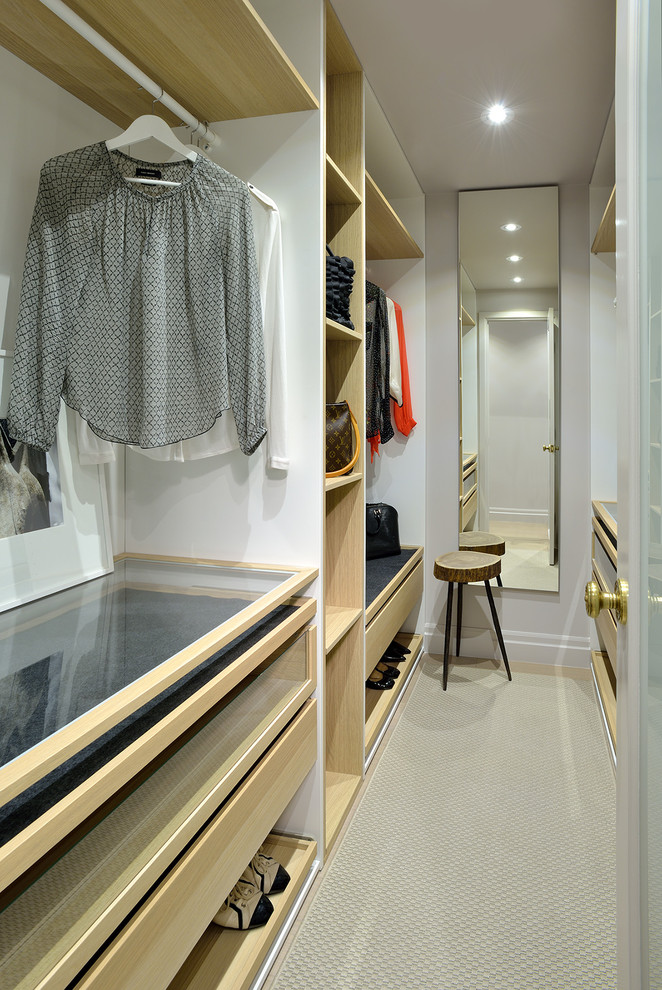 Design ideas for a small contemporary gender-neutral walk-in wardrobe in Toronto with open cabinets, light wood cabinets and light hardwood floors.