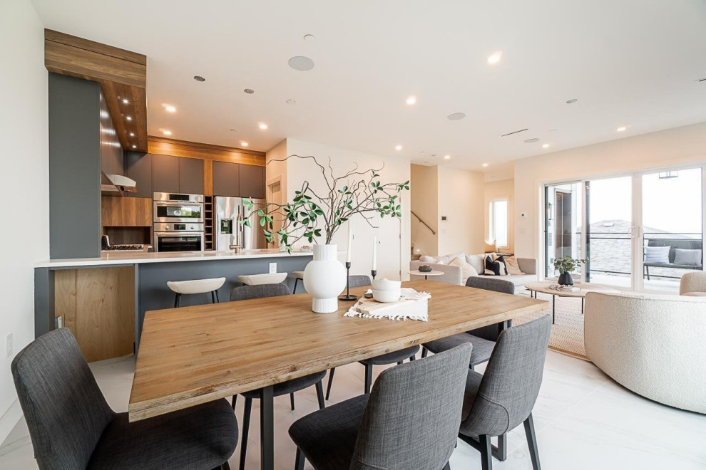 Inspiration for a mid-sized transitional ceramic tile and white floor great room remodel in Vancouver with white walls and no fireplace