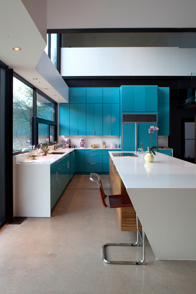 Design ideas for a modern open plan kitchen in Austin with flat-panel cabinets, blue cabinets, quartz benchtops, white splashback, panelled appliances and an undermount sink.