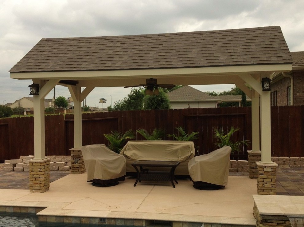 Design ideas for a large modern backyard patio in Houston with stamped concrete and no cover.