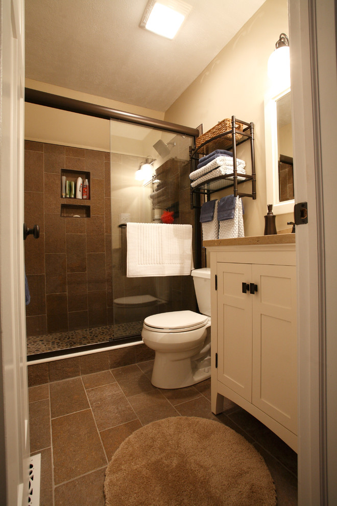 Small 3/4 gray tile and porcelain tile porcelain tile and gray floor alcove shower photo in Indianapolis with beaded inset cabinets, white cabinets, a two-piece toilet, beige walls and quartz countertops