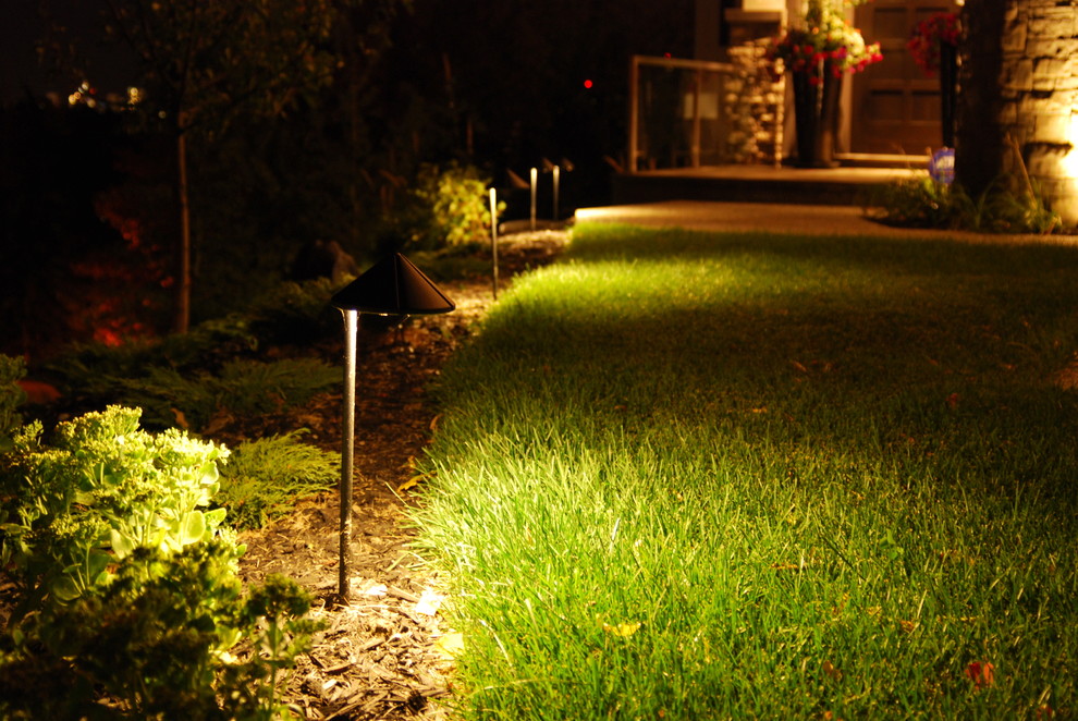 This is an example of a mid-sized rustic front yard concrete paver garden path in Calgary.