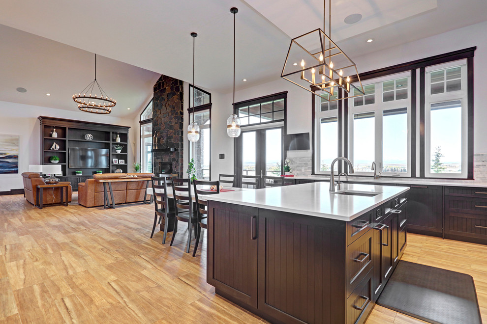 Inspiration for a transitional porcelain tile kitchen remodel in Calgary with an undermount sink, shaker cabinets, dark wood cabinets, quartzite countertops, multicolored backsplash, stainless steel appliances and an island