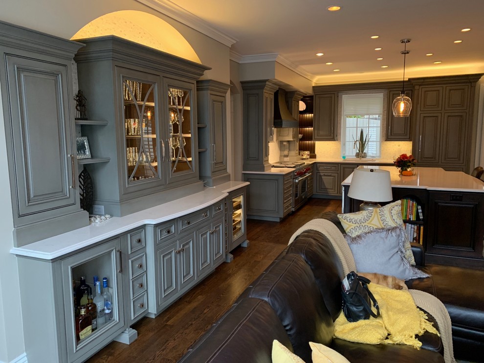 Large transitional single-wall medium tone wood floor and brown floor kitchen photo in Denver with a single-bowl sink, beaded inset cabinets, gray cabinets, quartz countertops, mosaic tile backsplash, paneled appliances, an island and beige countertops