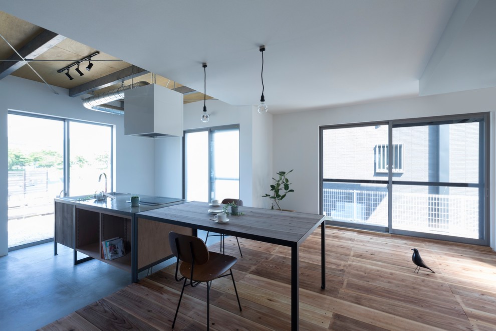 This is an example of a mid-sized industrial single-wall open plan kitchen in Other with an undermount sink, open cabinets, medium wood cabinets, concrete benchtops, beige splashback, porcelain splashback, black appliances, concrete floors, with island, grey floor and grey benchtop.